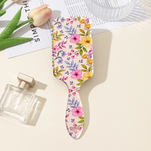 Dettaglio spazzola per capelli floreale con cuscino d'aria su manico in ABS beige