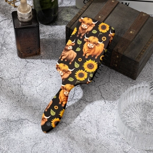 Macro detail of cow and sunflower pattern air cushion comb on rustic grey stone surface
