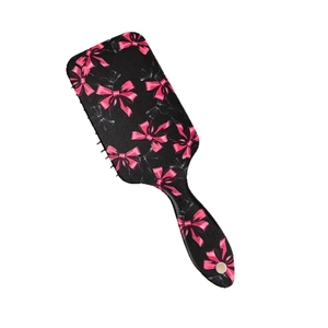 Spazzola pneumatica nera con fiocchi rosa per districare i capelli e massaggio cutaneo