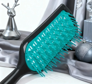 Close-up of professional vented hairbrush with flexible green bristles and a hollow design