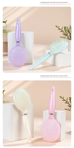 Detailed view of pearlescent cushion hairbrushes in soft pastel colors and ergonomic handles