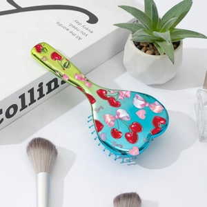 Heart-shaped cherry bow print hairbrush with green-blue gradient cushion and handle
