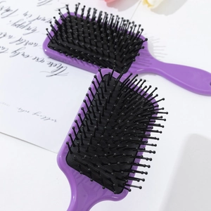 Set of two purple air cushion hairbrushes with black bristles for daily styling