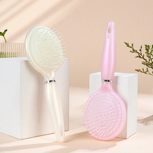 Elegant pearl white and pink air cushion massage combs with rounded ergonomic handles