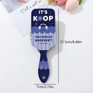 Detail view of air cushion hairbrush showing dimensions and blue cartoon monster design