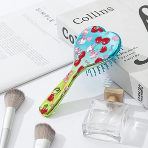 Heart-shaped air cushion hairbrush with cherry and bow print on blue gradient finish