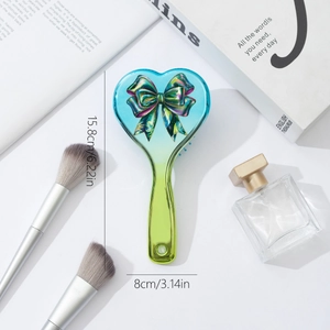 Gradient heart hairbrush with bow design and air cushion, measuring 15.8cm x 8cm
