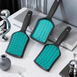 Three-piece vented hair brush set in black and turquoise with ergonomic handle design