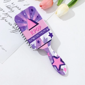 Detail of KPOP themed star pattern hair brush with massage bristles and purple gradient finish