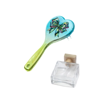 Gradient heart-shaped hair brush with bow pattern and soft cushion on white background