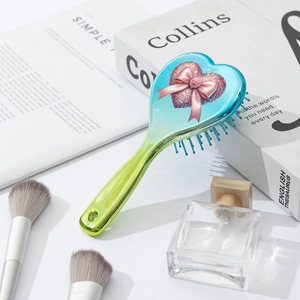 Gradient heart hairbrush with glitter bow design and blue massage air cushion bristles