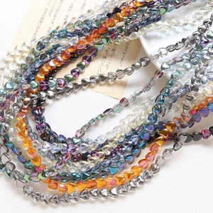 Macro detail of heart-shaped glass beads with iridescent coating for DIY jewelry