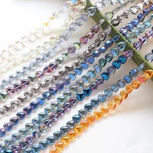 Macro shot of colorful iridescent heart-shaped glass beads for DIY jewelry making