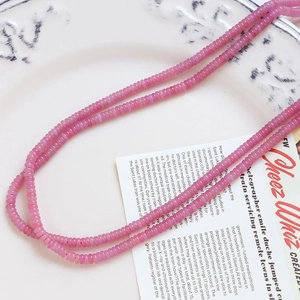 Close-up of natural pink agate beads with smooth texture for DIY jewelry making