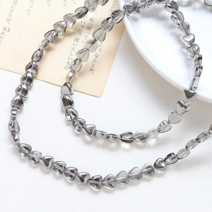 Close-up of heart-shaped smoky grey crystal glass beads for DIY jewelry making