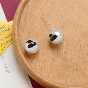 Macro detail of Halloween ghost beads with witch hat prints for DIY jewelry making