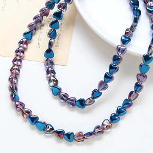 Close-up of heart-shaped blue and purple plated glass beads for DIY jewelry making