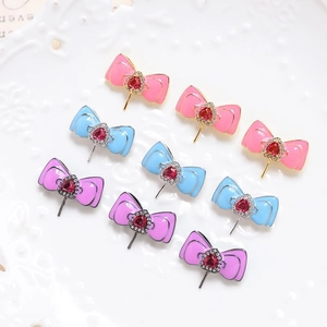 Gold-plated bow tie jewelry components with heart crystals and enamel for DIY accessories
