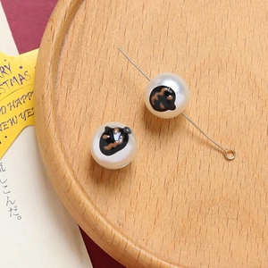 Detail of DIY pearl bead with festive pumpkin face print and metal pin for jewelry making