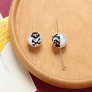 Detail of Halloween ghost and skull print beads for DIY jewelry making on wood tray