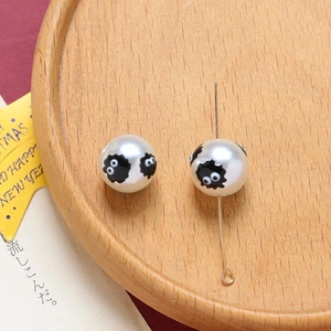 Detail of white acrylic beads with soot sprite print on gold metal pins for DIY crafts