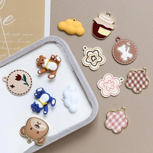 Macro detail of colorful bear and floral alloy charms for DIY jewelry and keychains