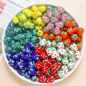 Close-up of assorted colorful strawberry glass beads for DIY jewelry making and crafts