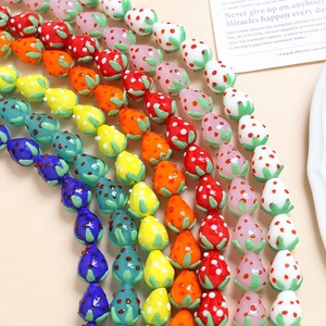 Detailed view of colorful strawberry glass beads for DIY handmade jewelry crafting