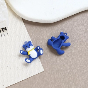 Front and back detail of blue cartoon bear charms for DIY jewelry making