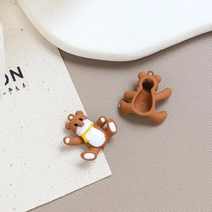 Detailed view of brown resin bear charms showing front and back for DIY jewelry making