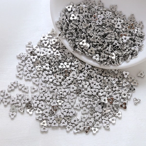Macro detail of silver clover flower metal spacer beads for DIY jewelry making