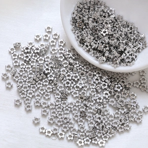Close-up of silver five-petal flower metal spacer beads for DIY jewelry making