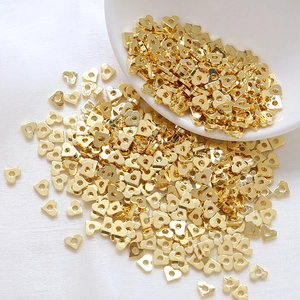 Detailed view of 18k gold-plated heart-shaped spacer beads for DIY jewelry making
