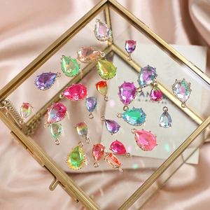 Detailed view of colorful teardrop crystal pendants with gold edges for DIY jewelry