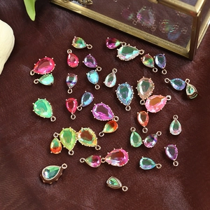 Macro shot of colorful pear-shaped crystal charms with metal bezel for DIY jewelry making
