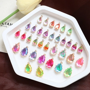 Macro detail of teardrop gradient crystal charms with metal edging for DIY jewelry making
