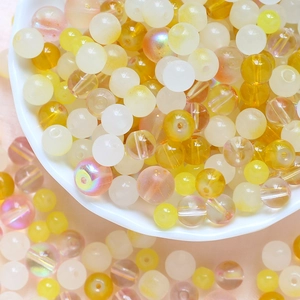 Detailed view of yellow and white mixed resin beads for DIY jewelry making