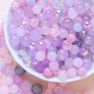 Macro shot of mixed purple and pink glass beads in a bowl for DIY jewelry making