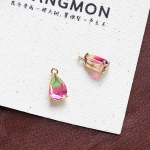 Detailed macro of faceted teardrop gradient pendants with golden claw settings for DIY jewelry