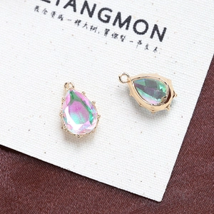 Macro detail of pear-shaped aurora crystal pendants with gold claw settings for jewelry DIY