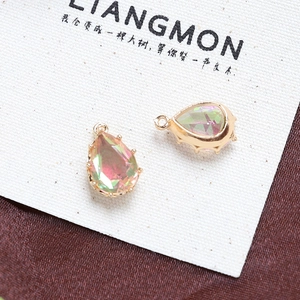Macro view of teardrop crystal pendants with faceted rainbow hues and golden claw settings