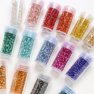 Detailed overhead view of multicolored 4mm glass seed beads in transparent tubes for DIY