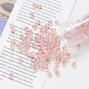 Macro view of 4mm pink glass seed beads with silver foil core for DIY jewelry making