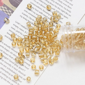Macro shot of 4mm glass beads with gold foil lining for DIY jewelry crafting
