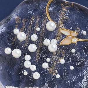 Elegant gold-plated open bangle with a large round pearl and a shell butterfly charm