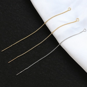 Macro detail of S925 sterling silver and gold-plated threader earrings for DIY jewelry