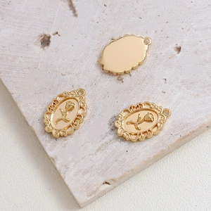 Macro detail of gold-plated rose flower pendant with vintage embossed relief texture