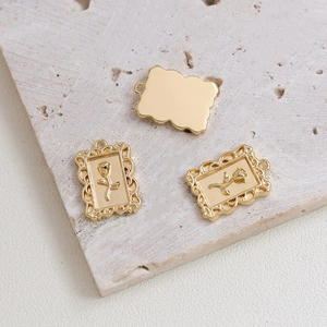 Detailed macro view of gold-plated rose flower pendant with a vintage rectangle frame design
