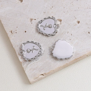 Detailed macro of heart-shaped rose pendants with vintage floral relief for DIY jewelry