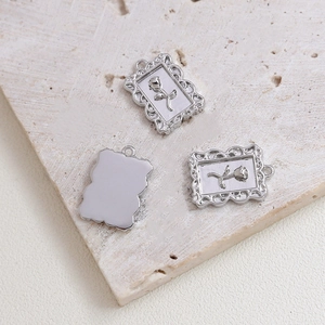 Macro shot of silver retro rose relief pendants showing baroque carved details and texture